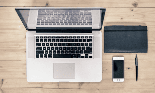 Photo of MacBook, iPhone, and agenda